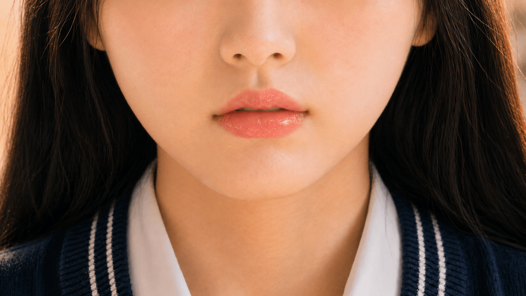 Close-up of lips with a soft pink tint.
