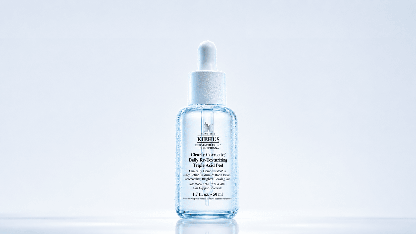 The serum bottle on a clean pale background