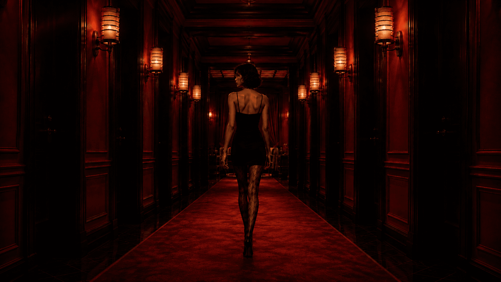 The woman walking away down a red hotel hallway
