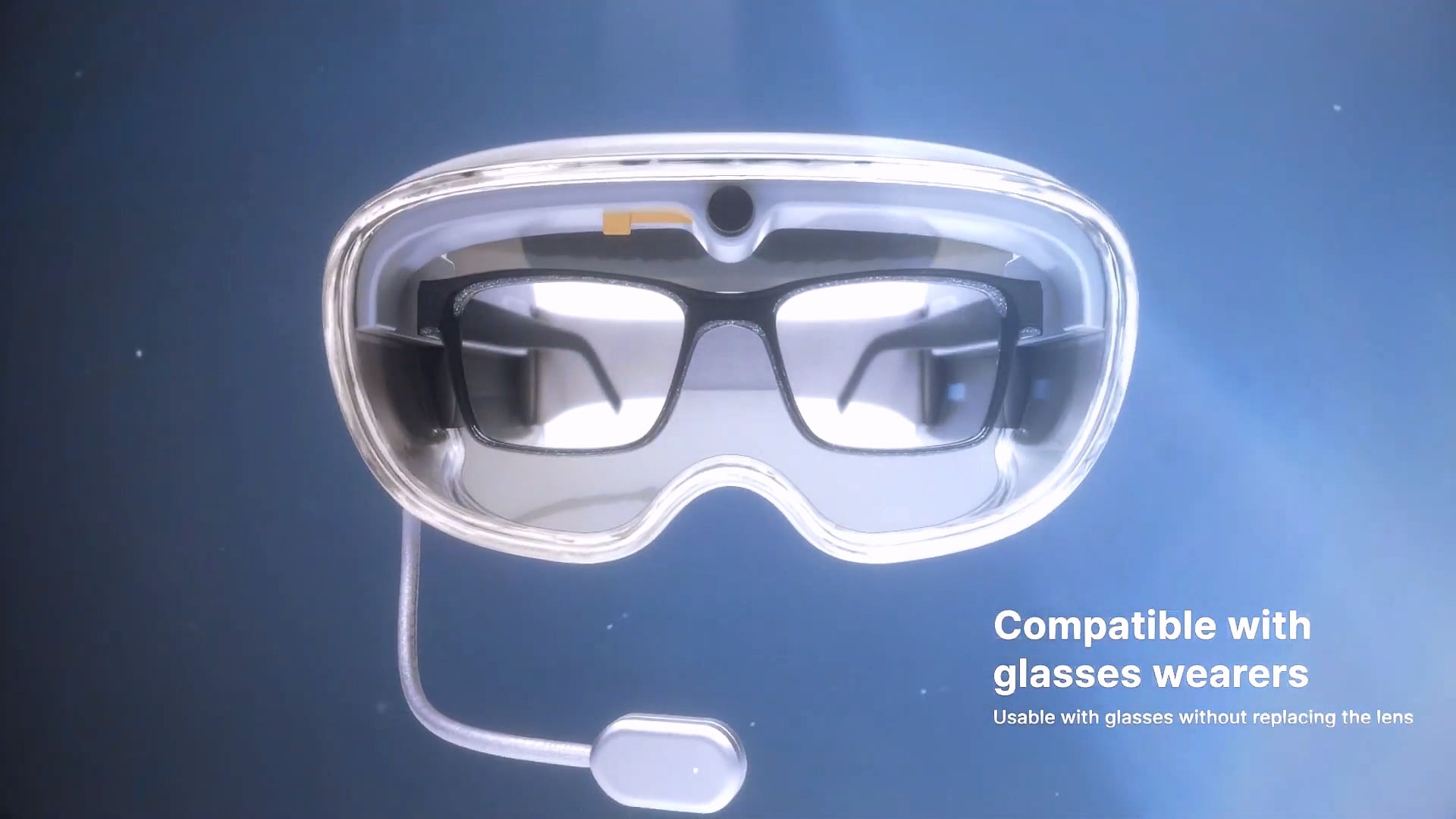 VisionX goggles from the front, worn over glasses, with a boom microphone.