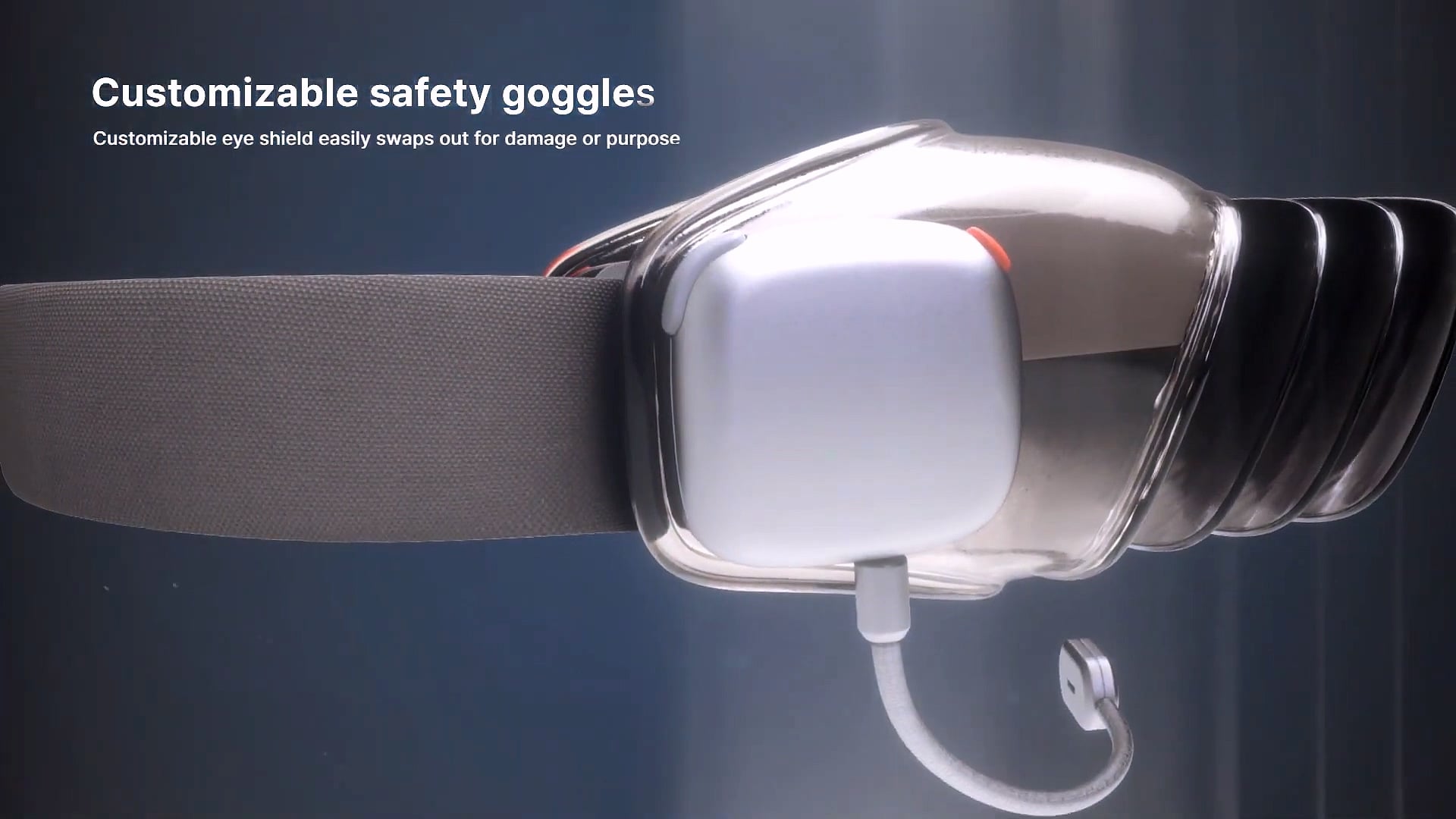 Side view of the goggles with head strap and boom microphone.