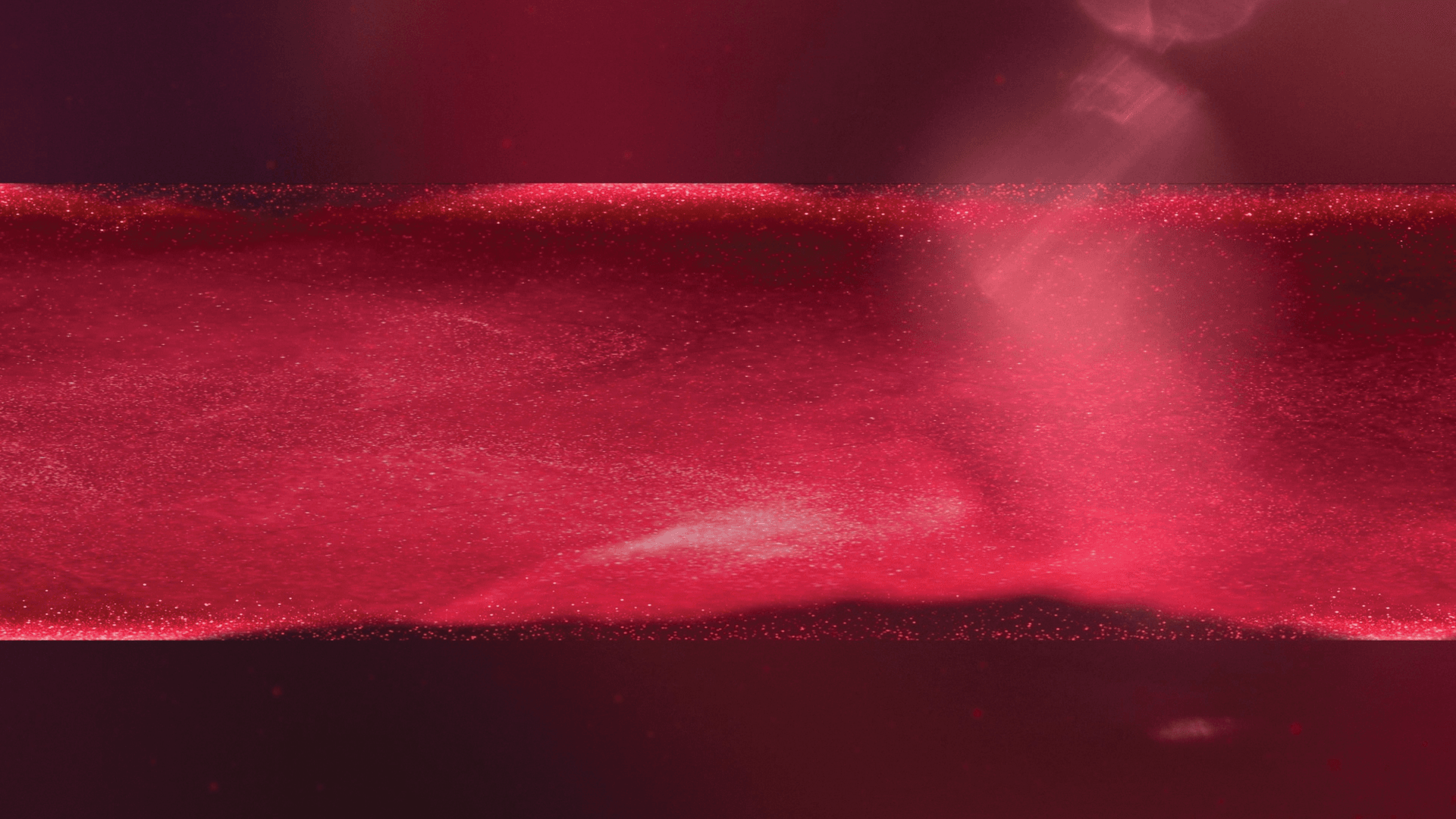 A field of red particles drifting through a dark red space.